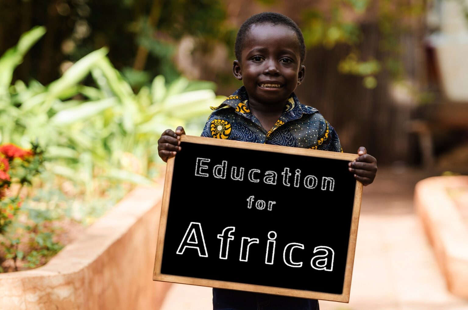 Child holding board with text