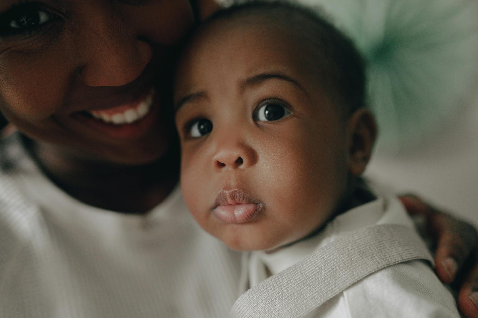 toddler and a woman in close up photography